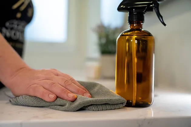 Cleaning supplies beside a freshly cleaned tabletop.