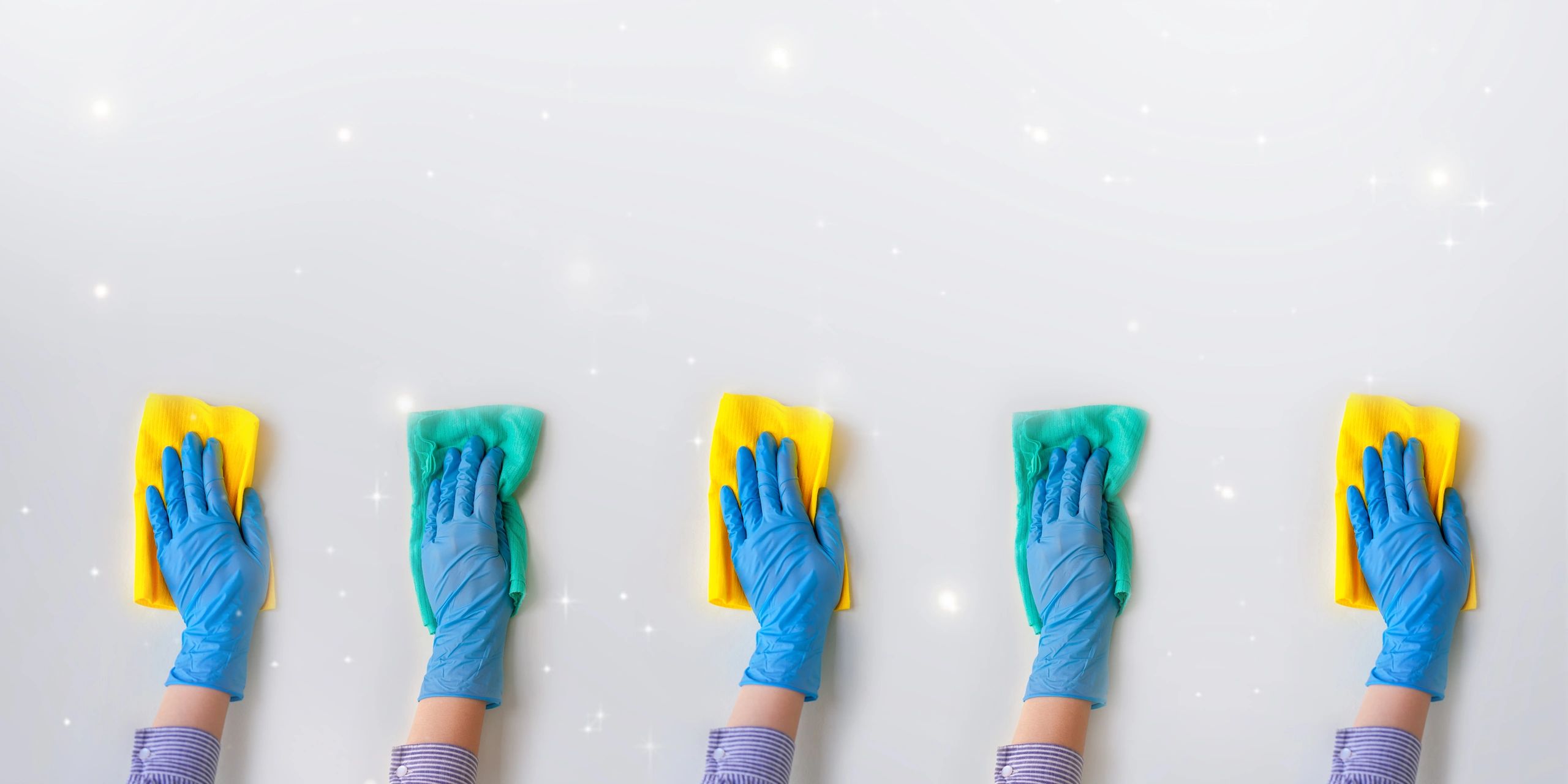 Employee hands in blue rubber protective glove wiping