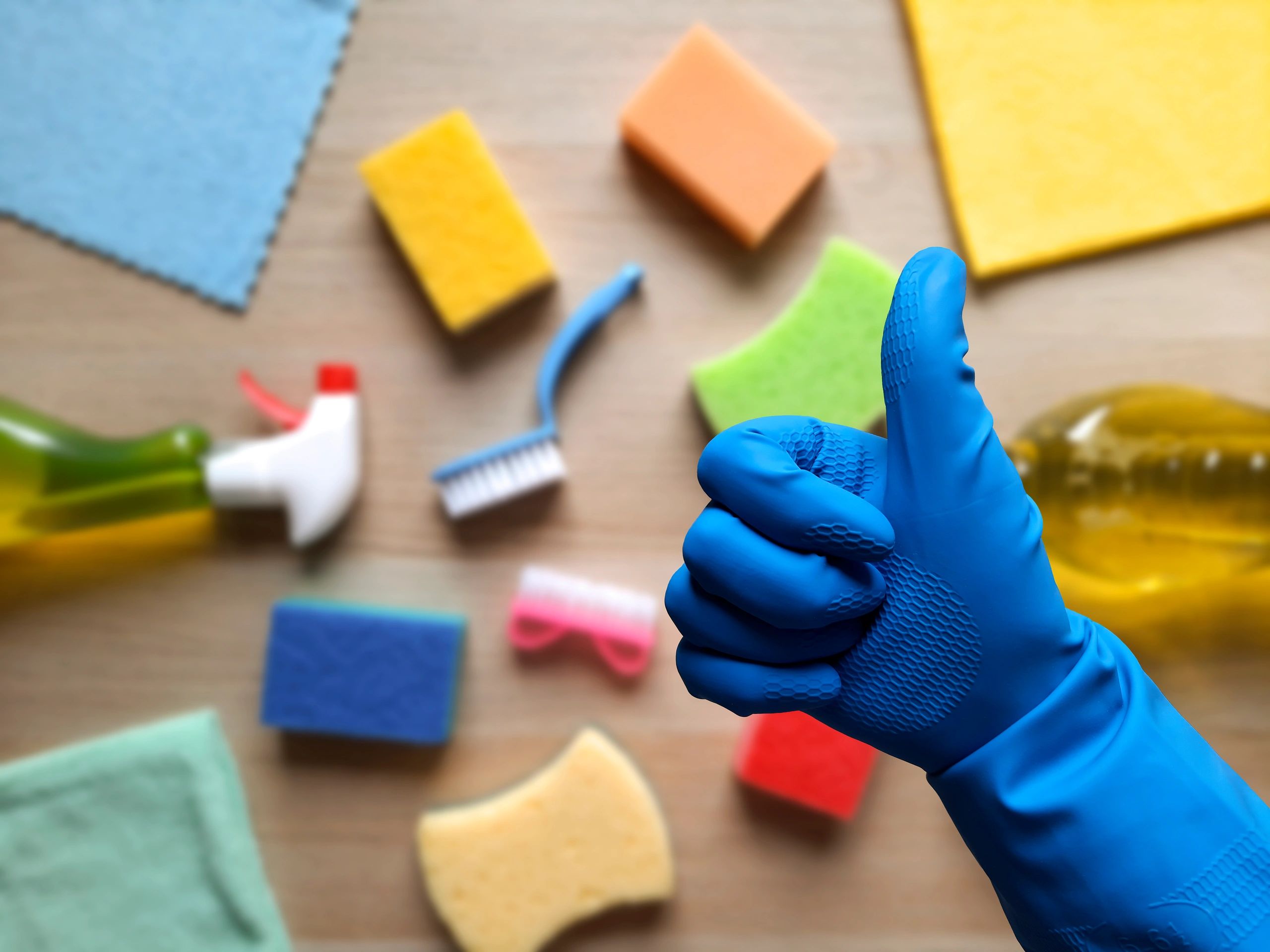 Like symbol, hand in rubber glove on defocused background.